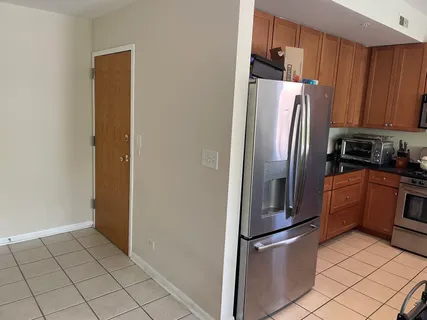 a metallic refrigerator freezer sitting in a kitchen