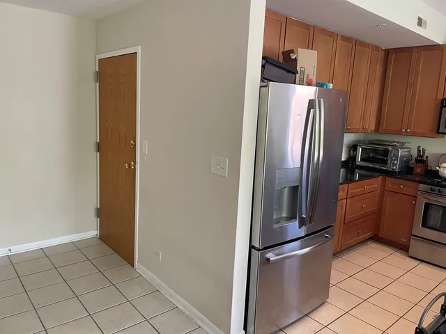a metallic refrigerator freezer sitting in a kitchen