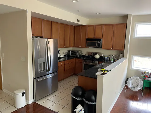 a kitchen with a refrigerator a stove and a sink