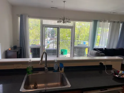 a kitchen with a sink and large window