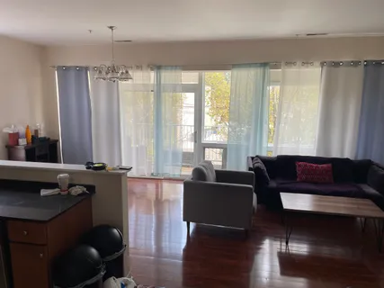 a living room with furniture and large windows