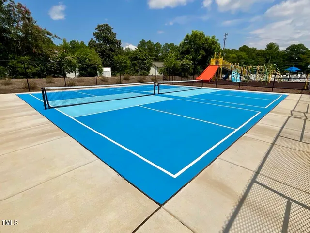 a view of tennis court with houses