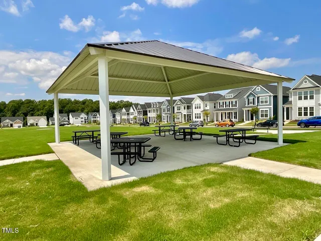 a view of a swimming pool with lawn chairs under an umbrella