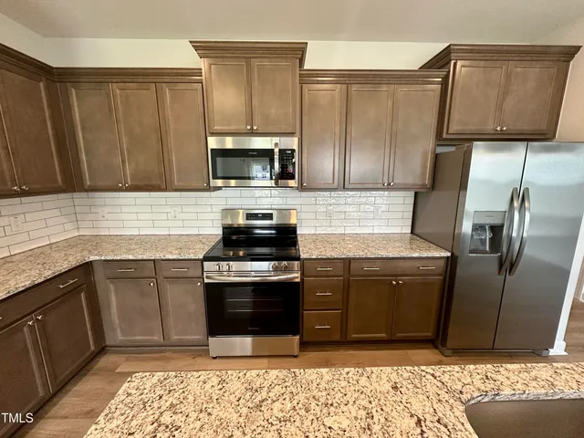 a kitchen with a sink stove and refrigerator