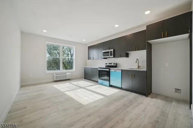 a view of kitchen with cabinets and stainless steel appliances