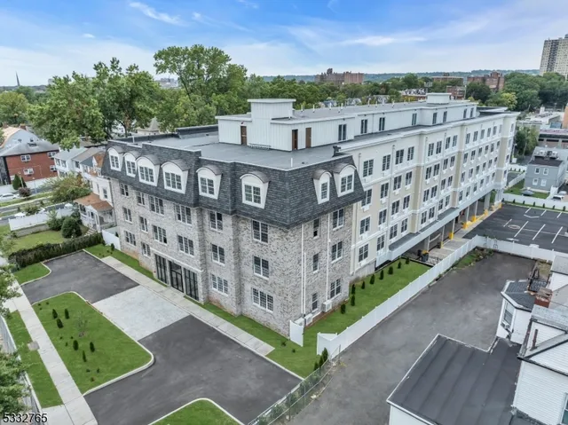 a view of a buildings with a yard