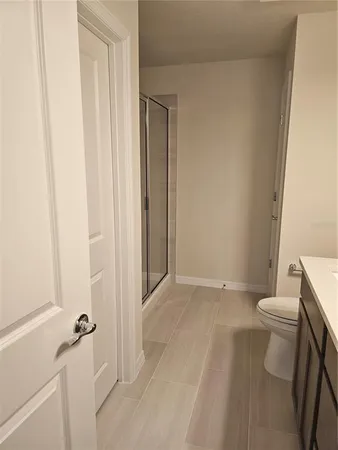 a bathroom with a glass shower door