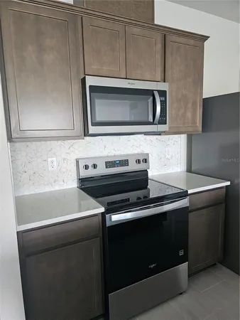a kitchen with a stove and a microwave