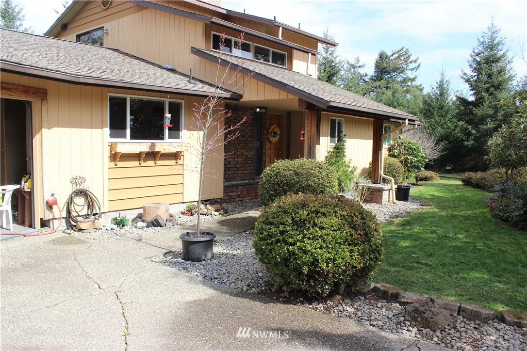 9344 Lundeen Road Southwest Rochester, WA 98579 - Photo 2 of 40 a front view of a house with garden