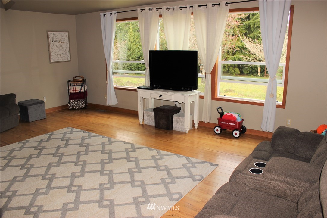 9344 Lundeen Road Southwest Rochester, WA 98579 - Photo 17 of 40 a living room with furniture and a flat screen tv