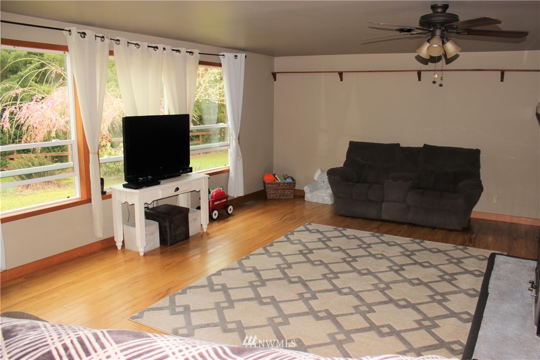 9344 Lundeen Road Southwest Rochester, WA 98579 - Photo 18 of 40 a living room with a couch and a flat screen tv