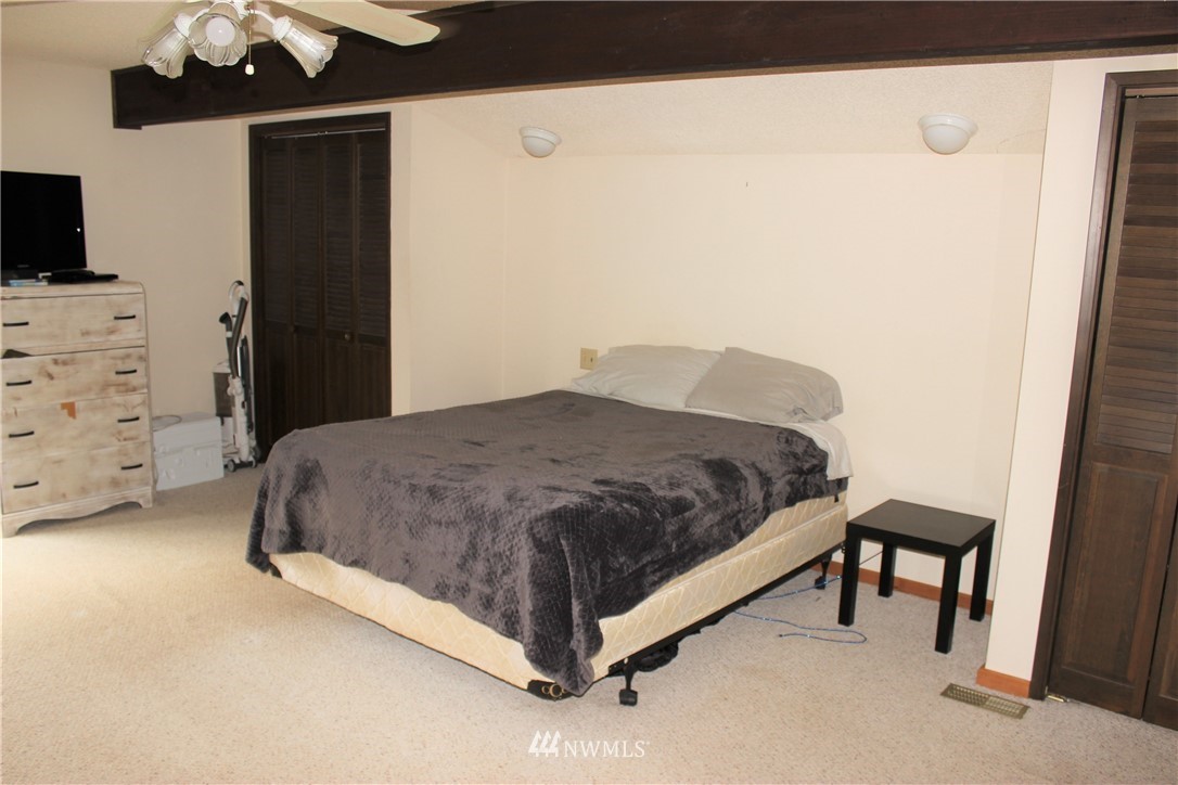 9344 Lundeen Road Southwest Rochester, WA 98579 - Photo 19 of 40 a spacious bedroom with a bed and a television