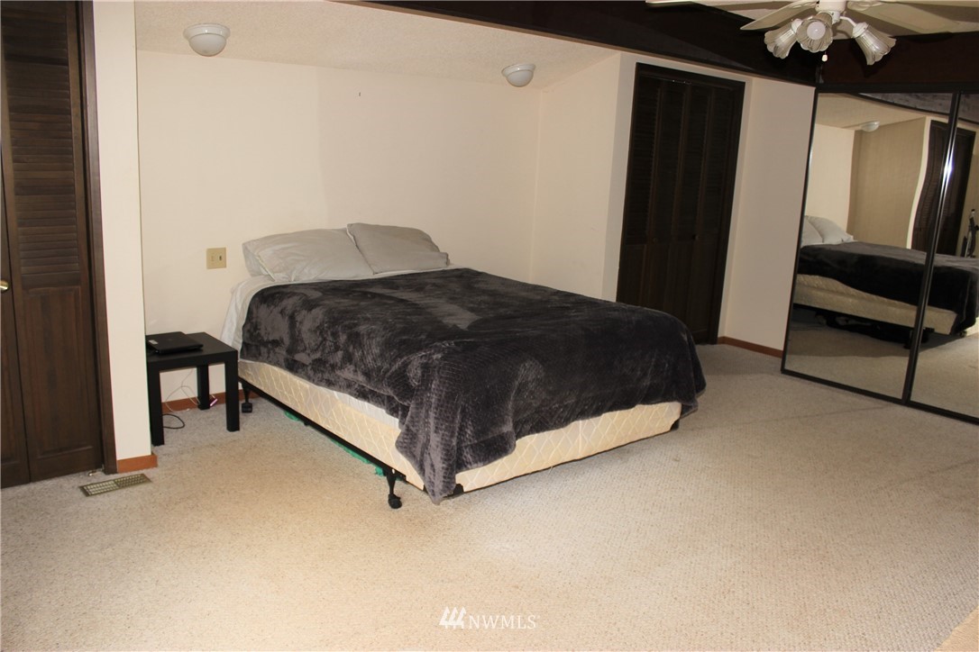 9344 Lundeen Road Southwest Rochester, WA 98579 - Photo 20 of 40 a bedroom with a bed and a dresser