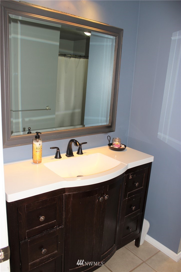 9344 Lundeen Road Southwest Rochester, WA 98579 - Photo 25 of 40 a bathroom with a sink vanity and a mirror