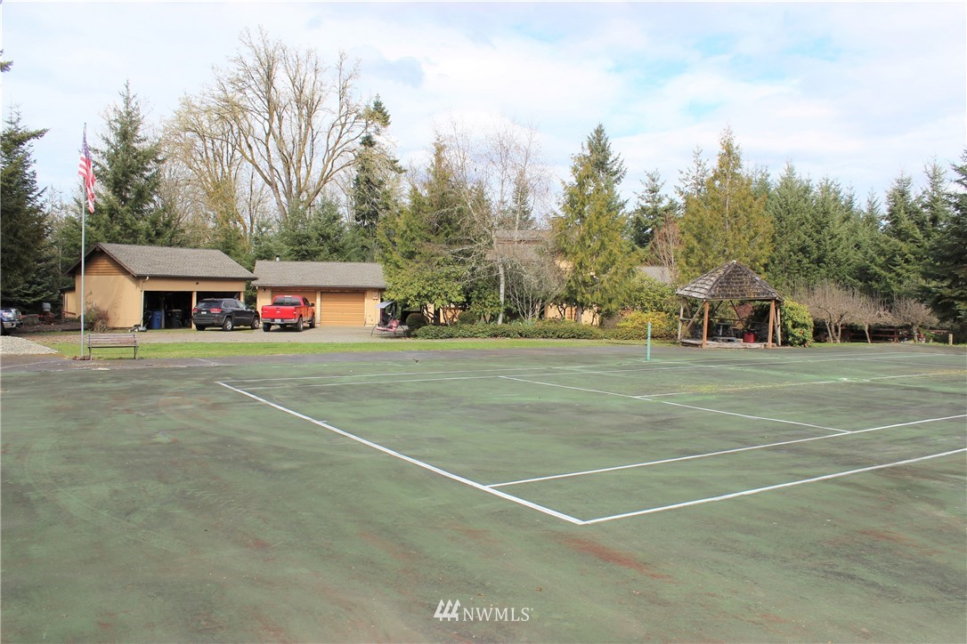 9344 Lundeen Road Southwest Rochester, WA 98579 - Photo 30 of 40 a view of a tennis ground with large trees