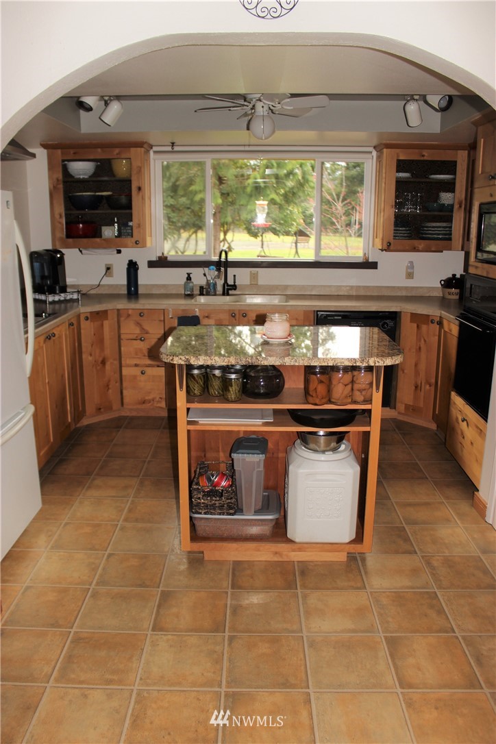 9344 Lundeen Road Southwest Rochester, WA 98579 - Photo 9 of 40 a kitchen with stainless steel appliances a stove a sink and a microwave