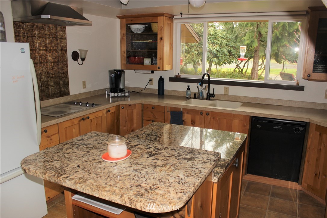 9344 Lundeen Road Southwest Rochester, WA 98579 - Photo 10 of 40 a kitchen with a sink and large window