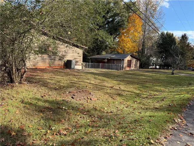 a front view of house with yard and trees around