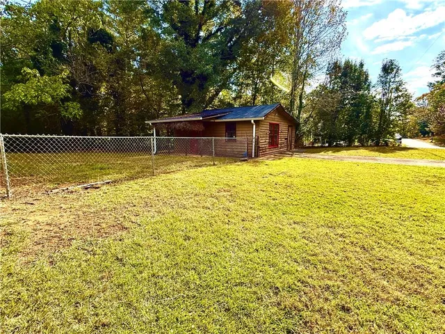 a swimming pool view with a seating space