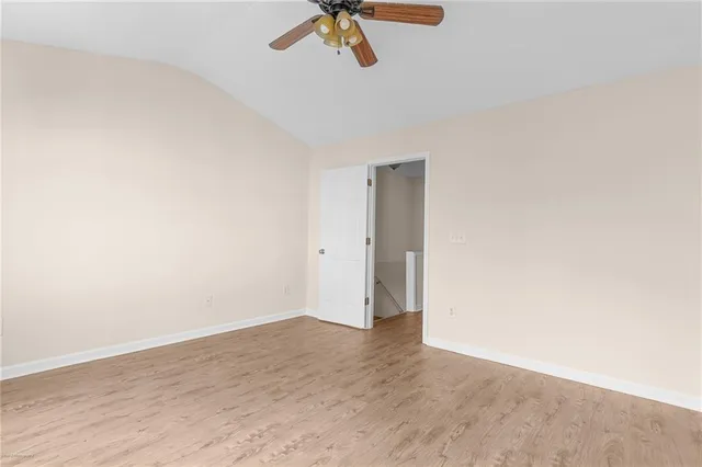 a view of a room with wooden floor and white walls