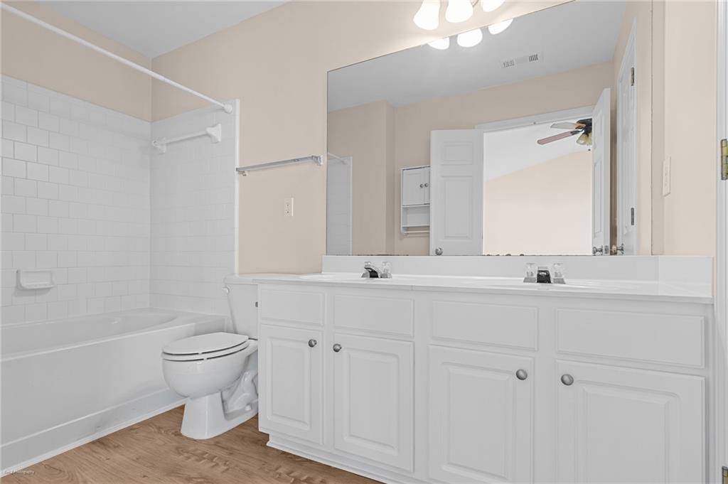 1010 Bendleton Trace Alpharetta, GA 30004 - Photo 16 of 25 a bathroom with a sink a toilet and a mirror