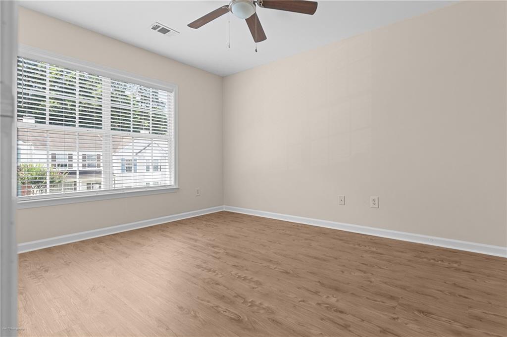 1010 Bendleton Trace Alpharetta, GA 30004 - Photo 17 of 25 a view of an empty room with wooden floor and a window