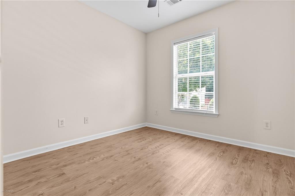 1010 Bendleton Trace Alpharetta, GA 30004 - Photo 19 of 25 an empty room with wooden floor and windows