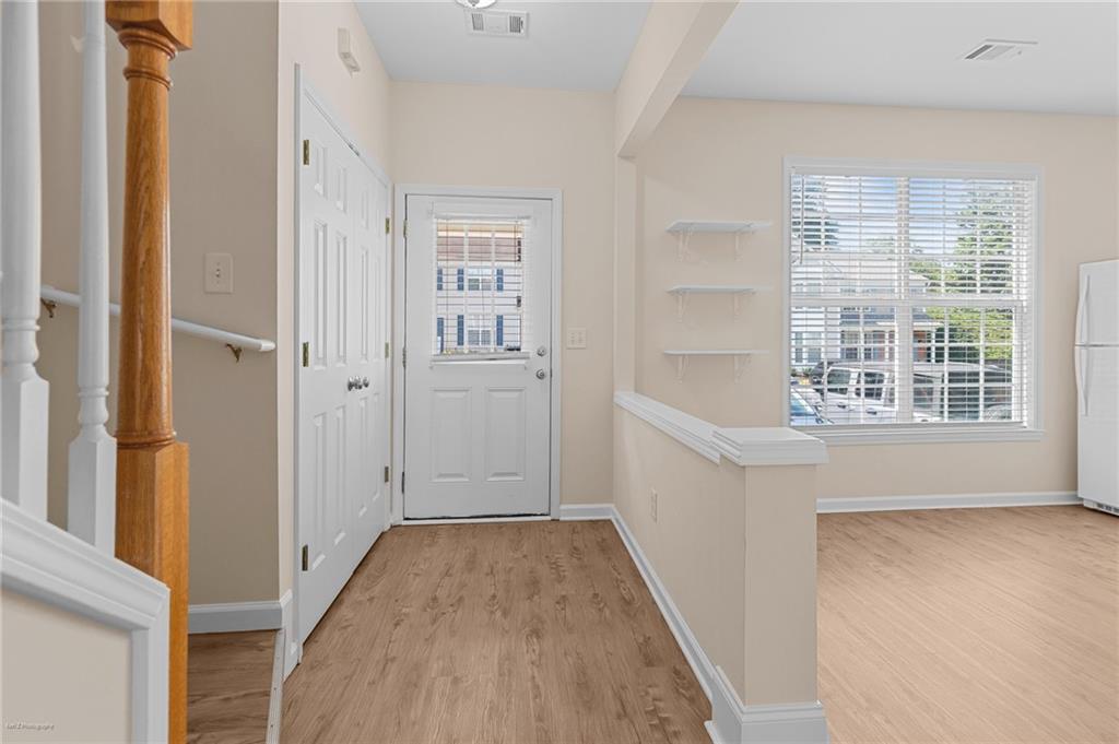 1010 Bendleton Trace Alpharetta, GA 30004 - Photo 2 of 25 wooden floor in an empty room with a window