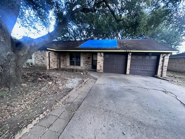 a front view of a house with yard and trees