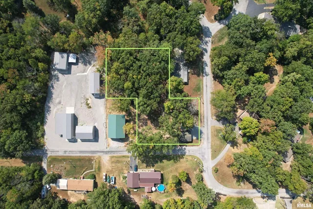 an aerial view of a house with a yard and fountain