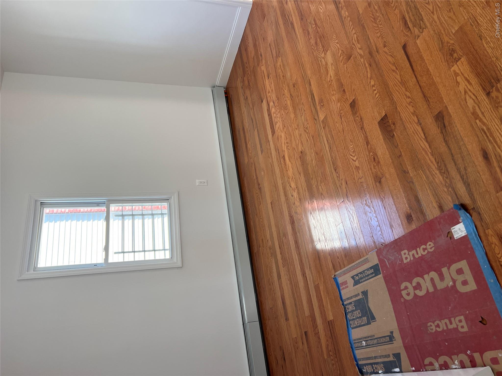 216-25 136th Road, Unit 1 2 AND 3 Queens, NY 11413 - Photo 13 of 43 an empty room with wooden floor and windows