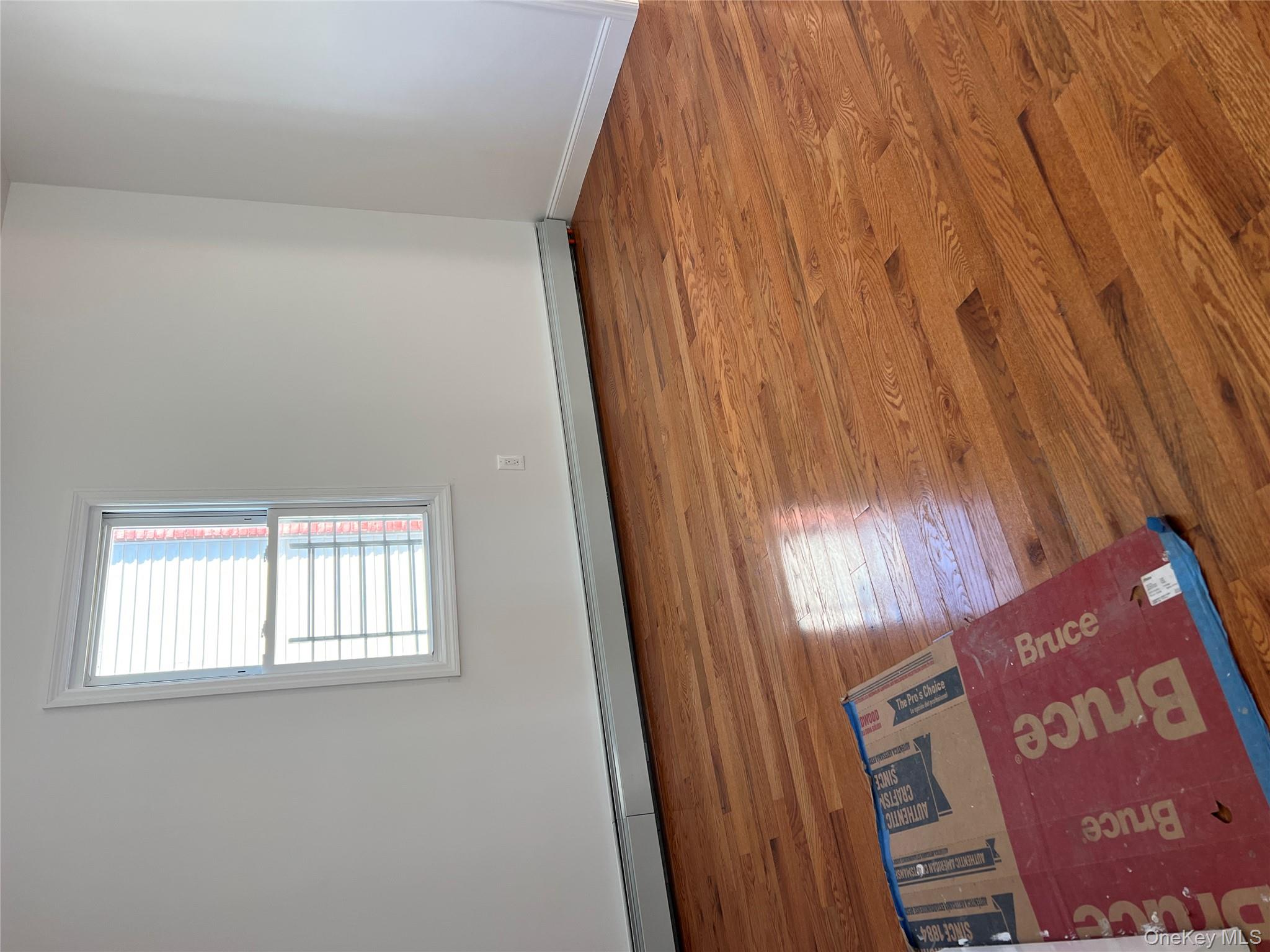 216-25 136th Road, Unit 1 2 AND 3 Queens, NY 11413 - Photo 13 of 43 an empty room with wooden floor and windows