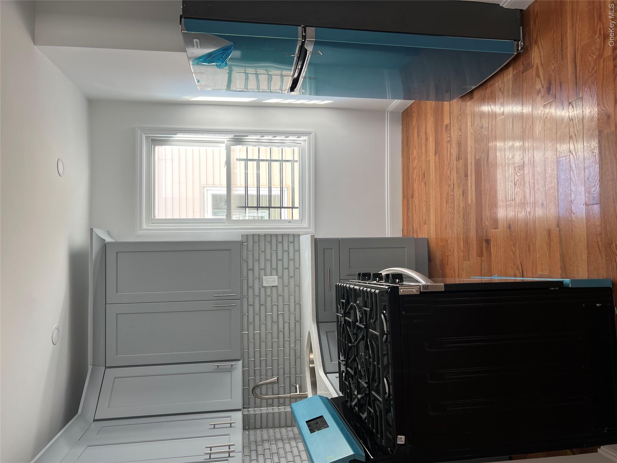 216-25 136th Road, Unit 1 2 AND 3 Queens, NY 11413 - Photo 14 of 43 a kitchen with a stove a refrigerator and a window