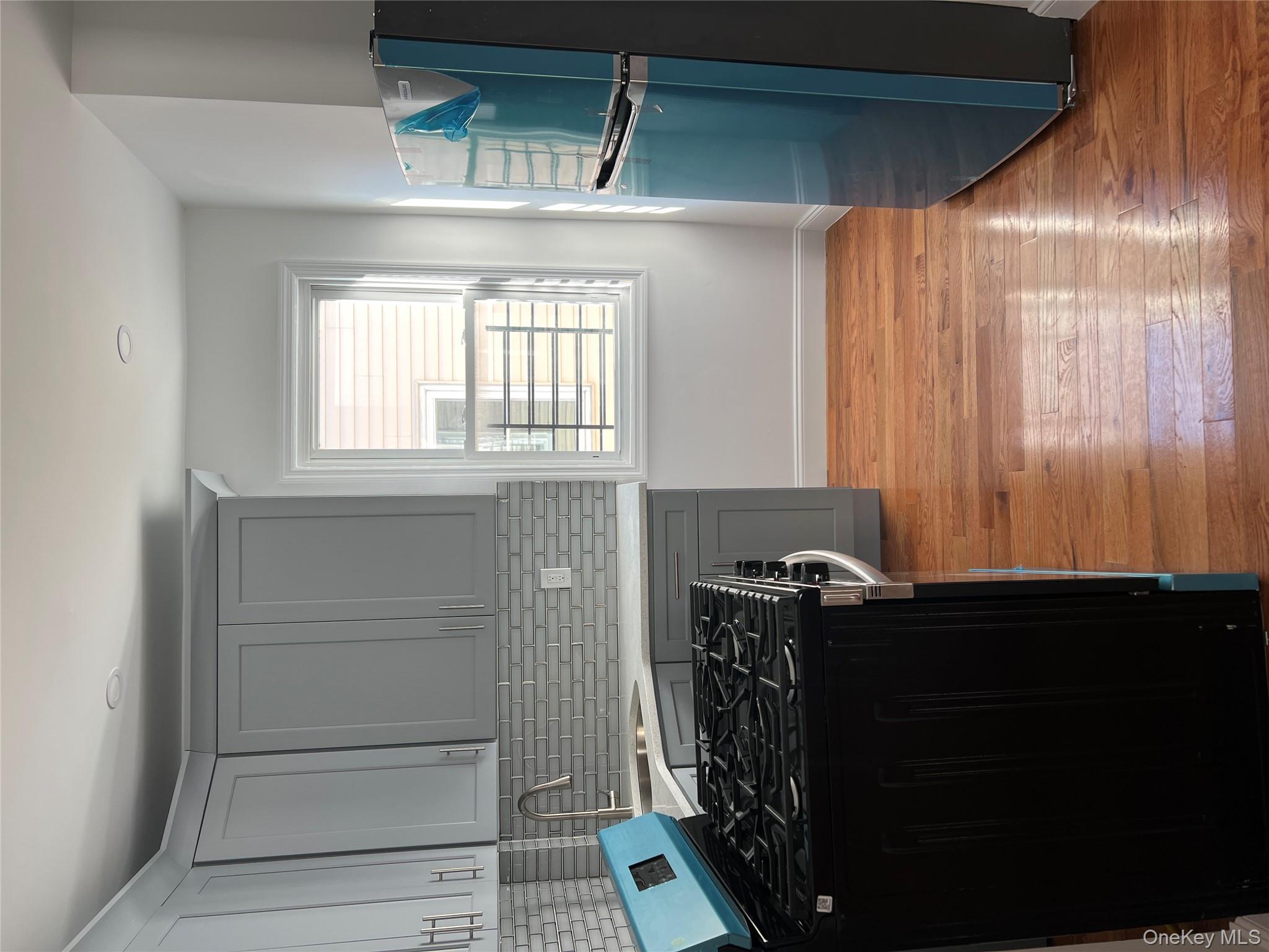 216-25 136th Road, Unit 1 2 AND 3 Queens, NY 11413 - Photo 14 of 43 a kitchen with a stove a refrigerator and a window