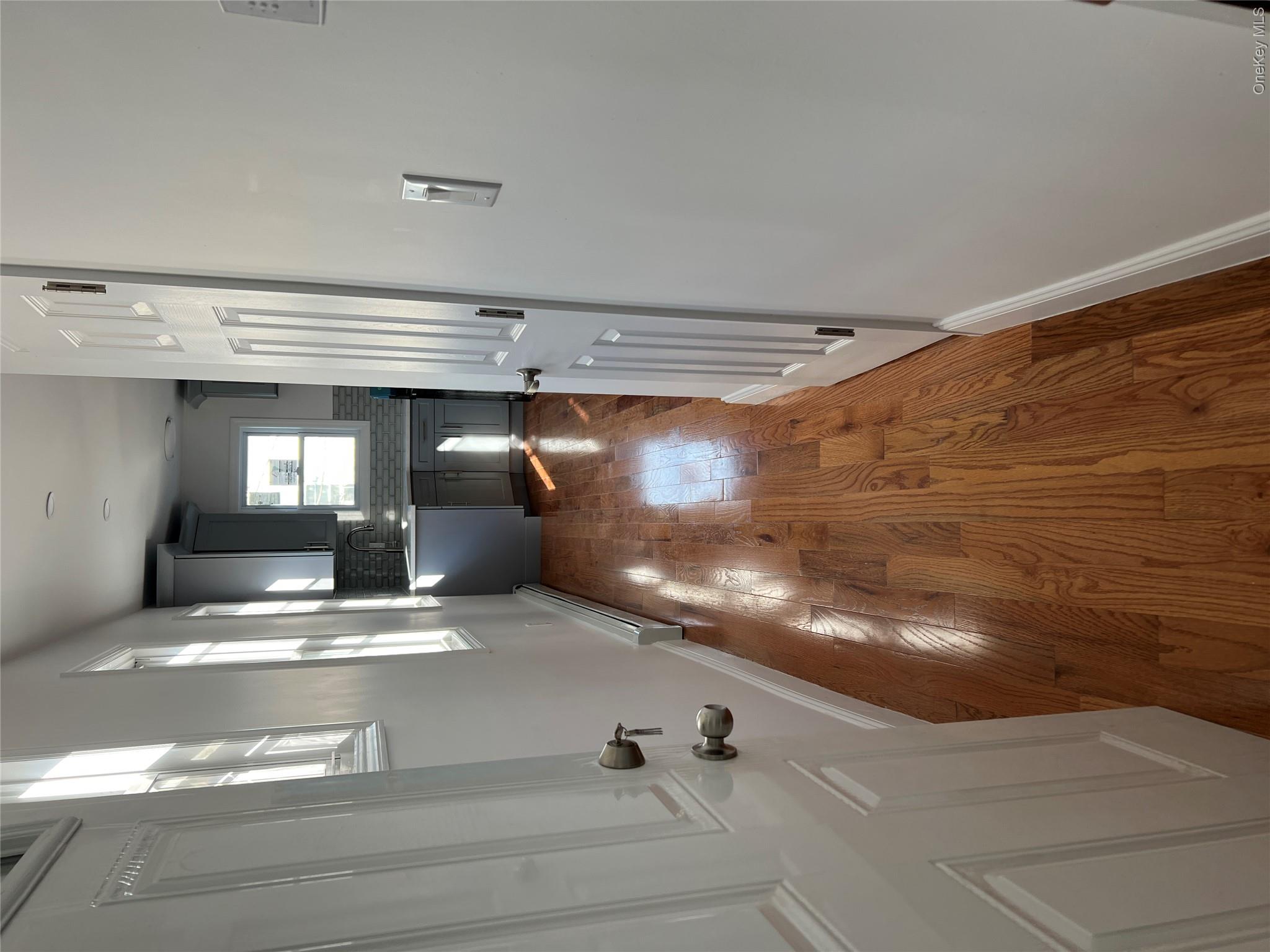 216-25 136th Road, Unit 1 2 AND 3 Queens, NY 11413 - Photo 15 of 43 a view of a hallway with wooden floor and staircase