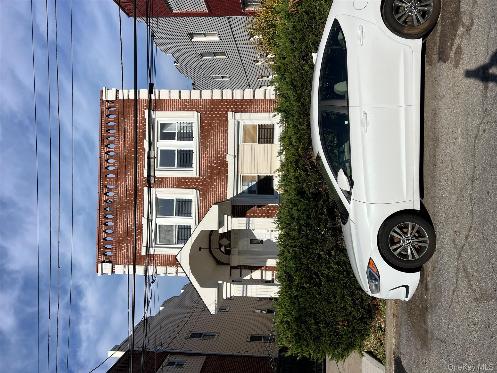 216-25 136th Road, Unit 1 2 AND 3 Queens, NY 11413 - Photo 2 of 43 a front view of a house with parking space