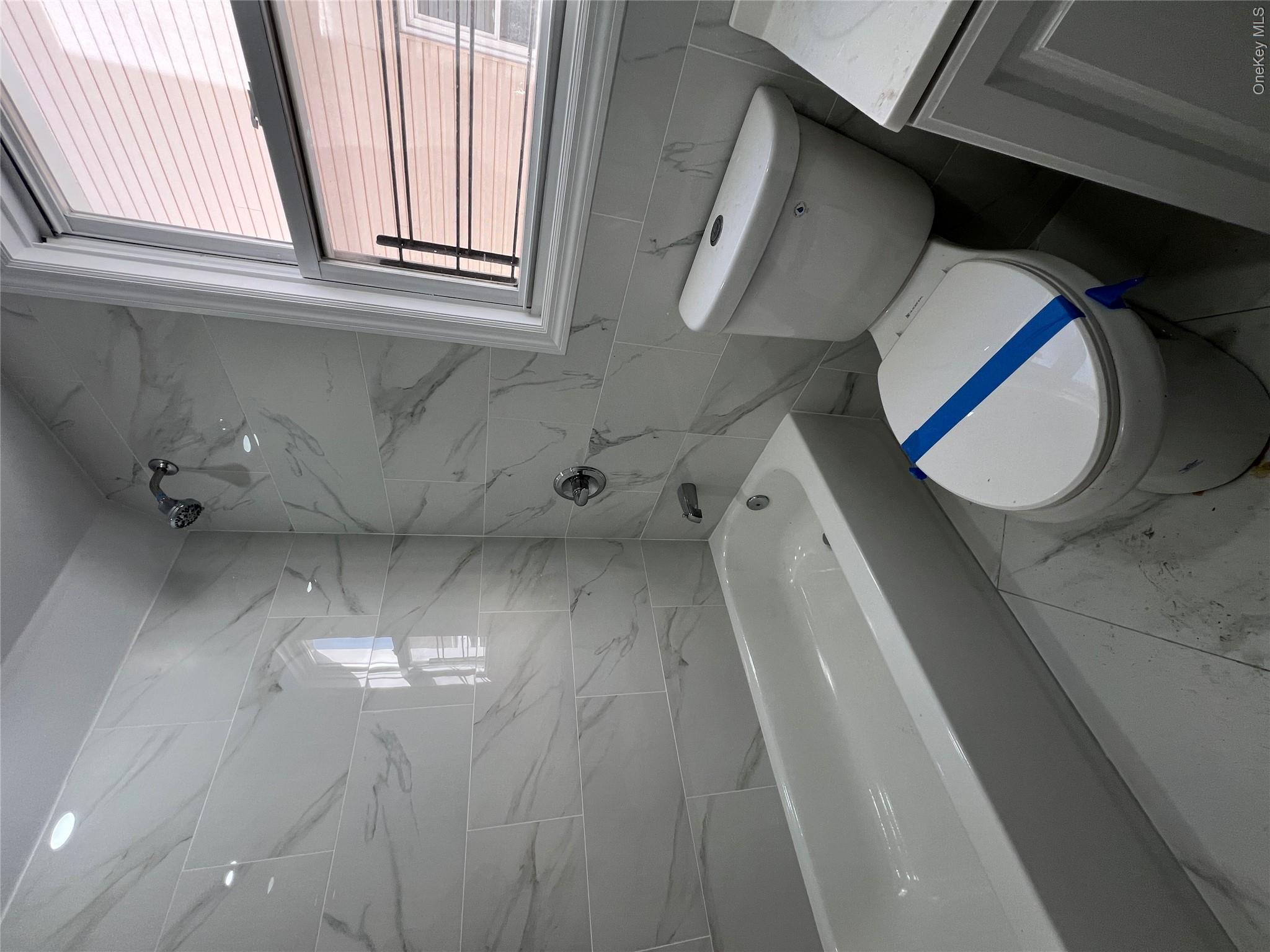 216-25 136th Road, Unit 1 2 AND 3 Queens, NY 11413 - Photo 21 of 43 a bathroom with a toilet a sink and bathtub