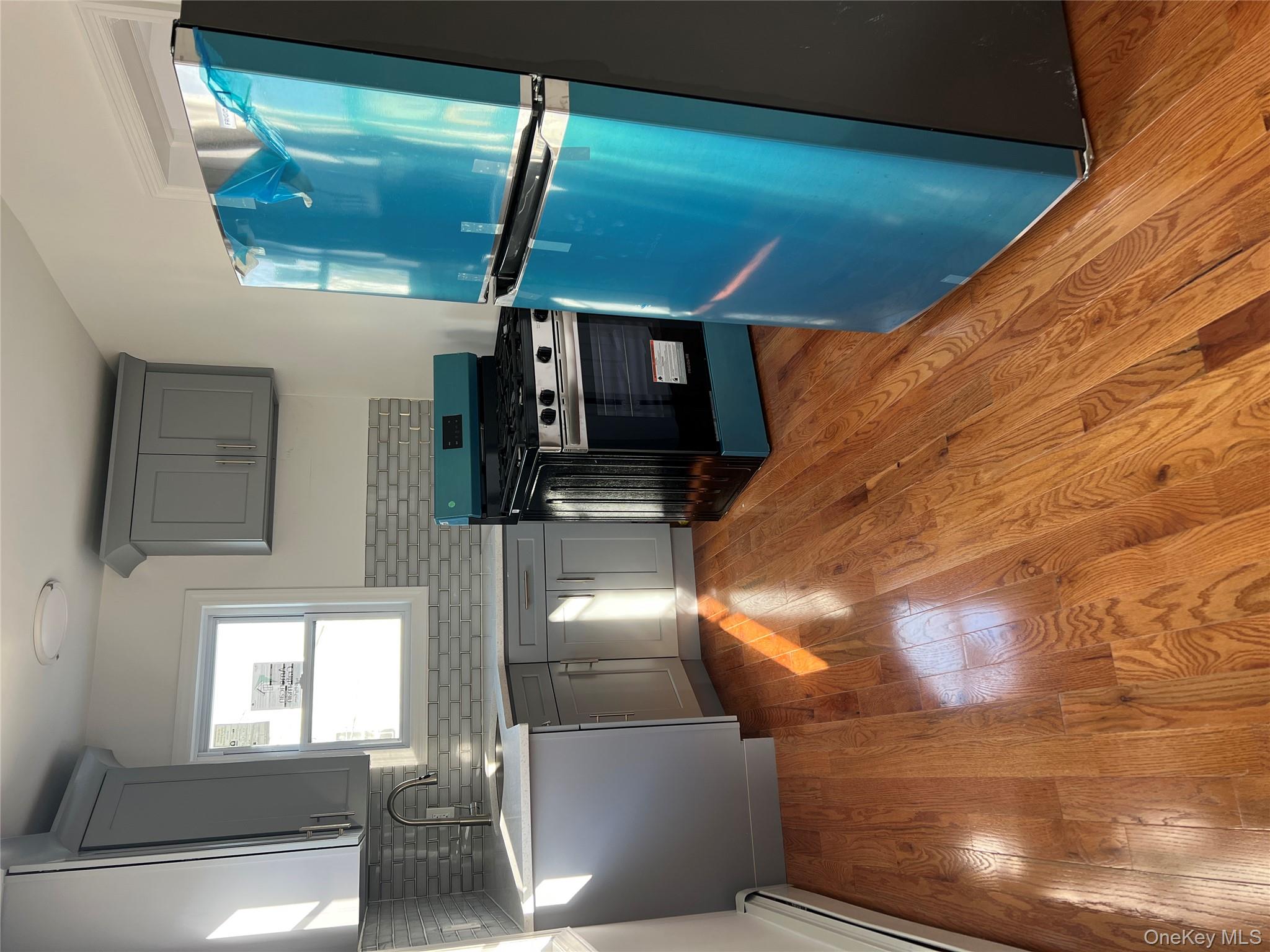 216-25 136th Road, Unit 1 2 AND 3 Queens, NY 11413 - Photo 25 of 43 a kitchen with granite countertop a refrigerator and a sink