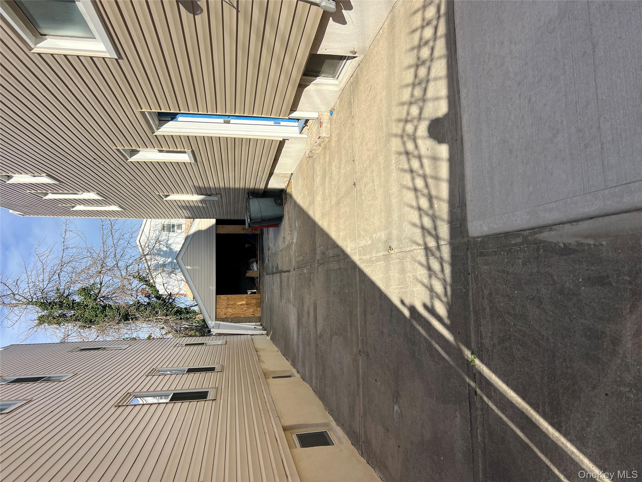 216-25 136th Road, Unit 1 2 AND 3 Queens, NY 11413 - Photo 27 of 43 a view of a porch with a table and chairs