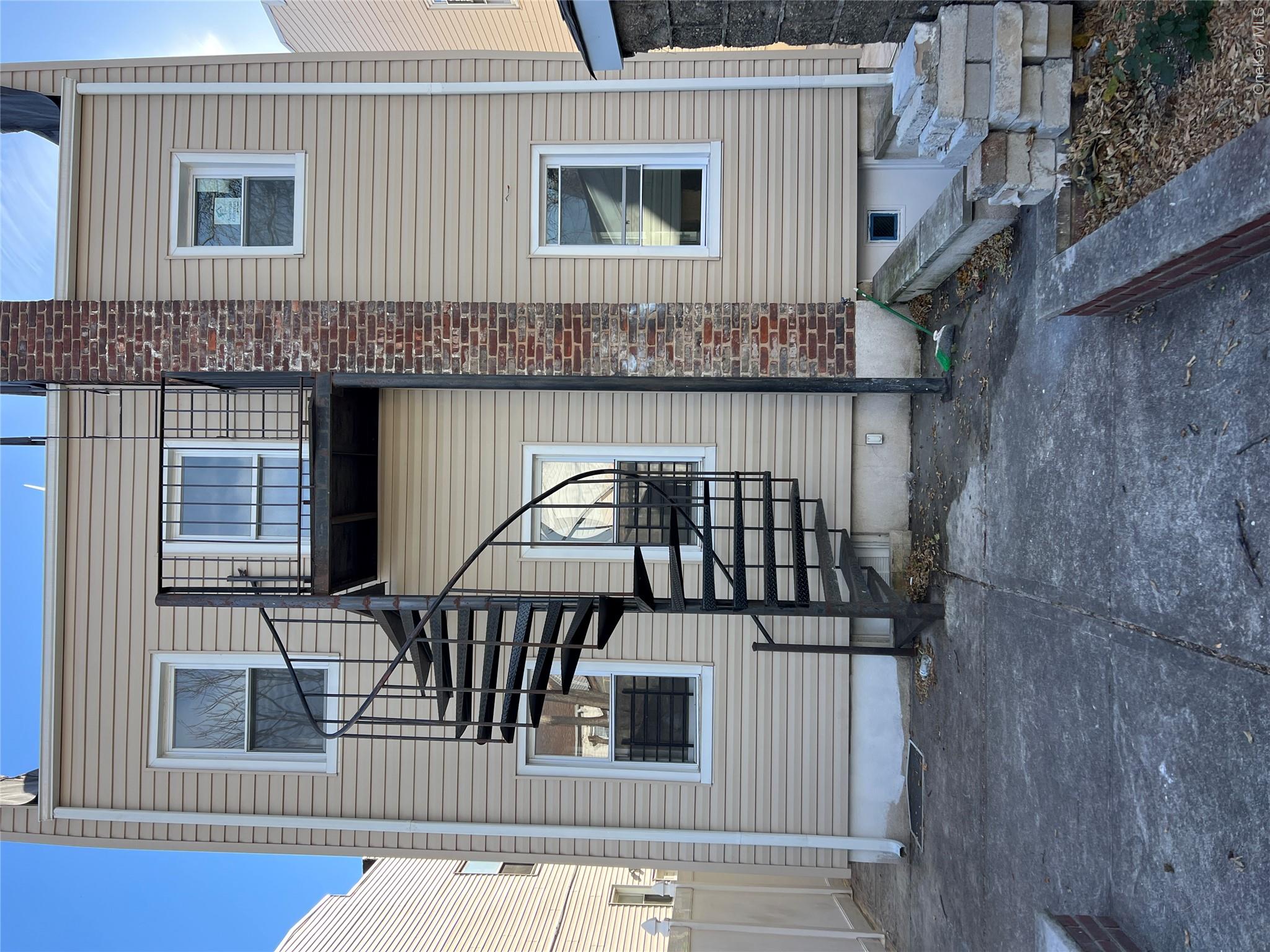 216-25 136th Road, Unit 1 2 AND 3 Queens, NY 11413 - Photo 29 of 43 a view of a house with a yard and garage