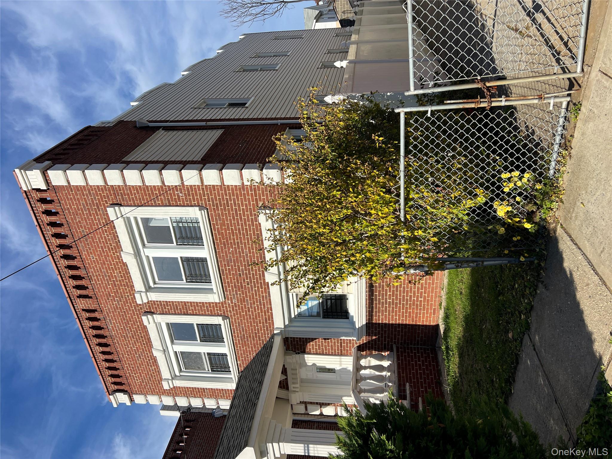 216-25 136th Road, Unit 1 2 AND 3 Queens, NY 11413 - Photo 3 of 43 a front view of a house with a garden
