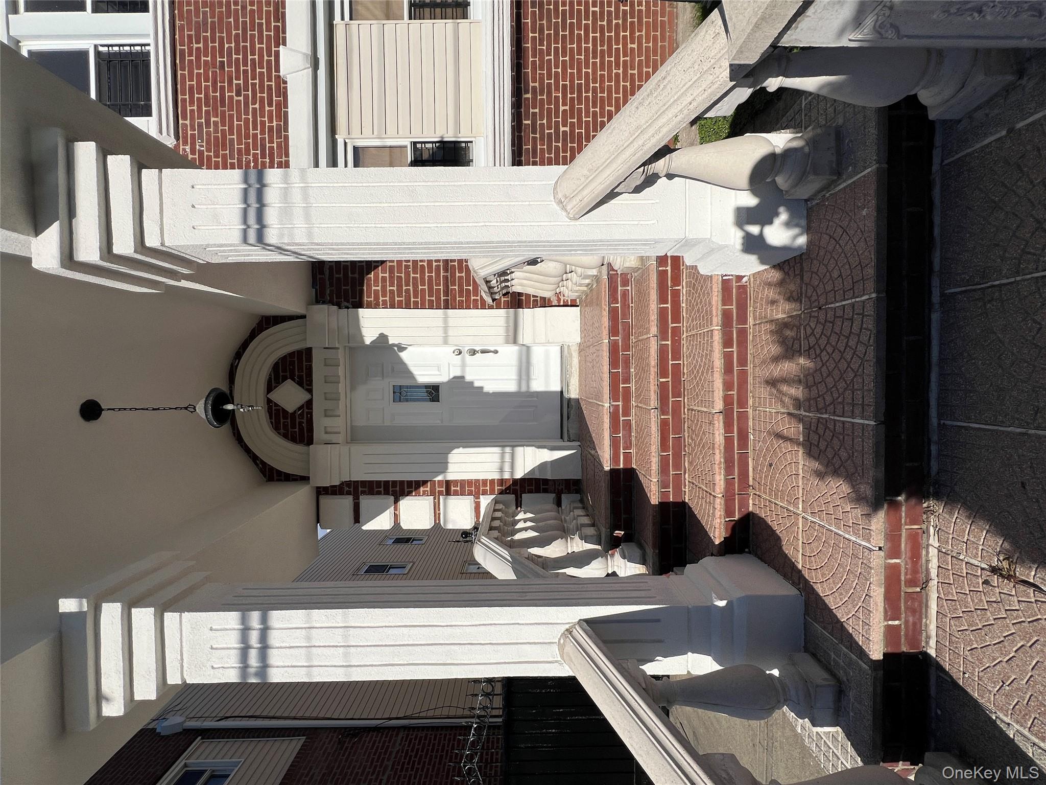 216-25 136th Road, Unit 1 2 AND 3 Queens, NY 11413 - Photo 36 of 43 a front view of a house with a garden