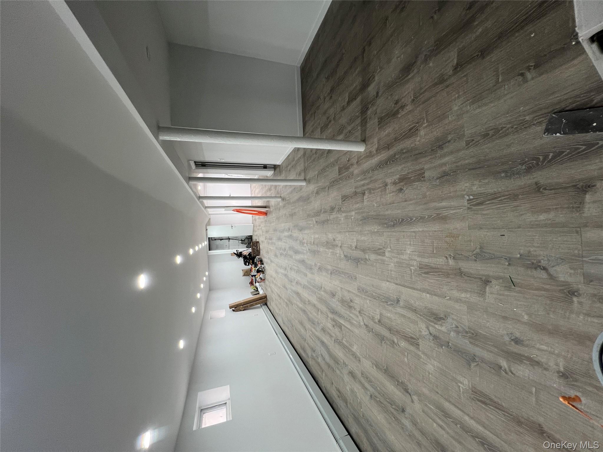 216-25 136th Road, Unit 1 2 AND 3 Queens, NY 11413 - Photo 42 of 43 a view of empty room with wooden floor