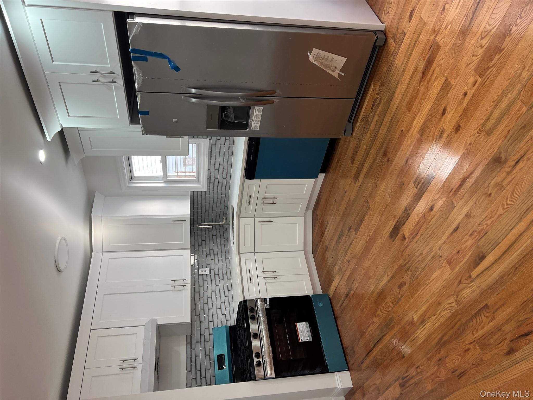 216-25 136th Road, Unit 1 2 AND 3 Queens, NY 11413 - Photo 43 of 43 a kitchen with granite countertop a refrigerator and a stove top oven