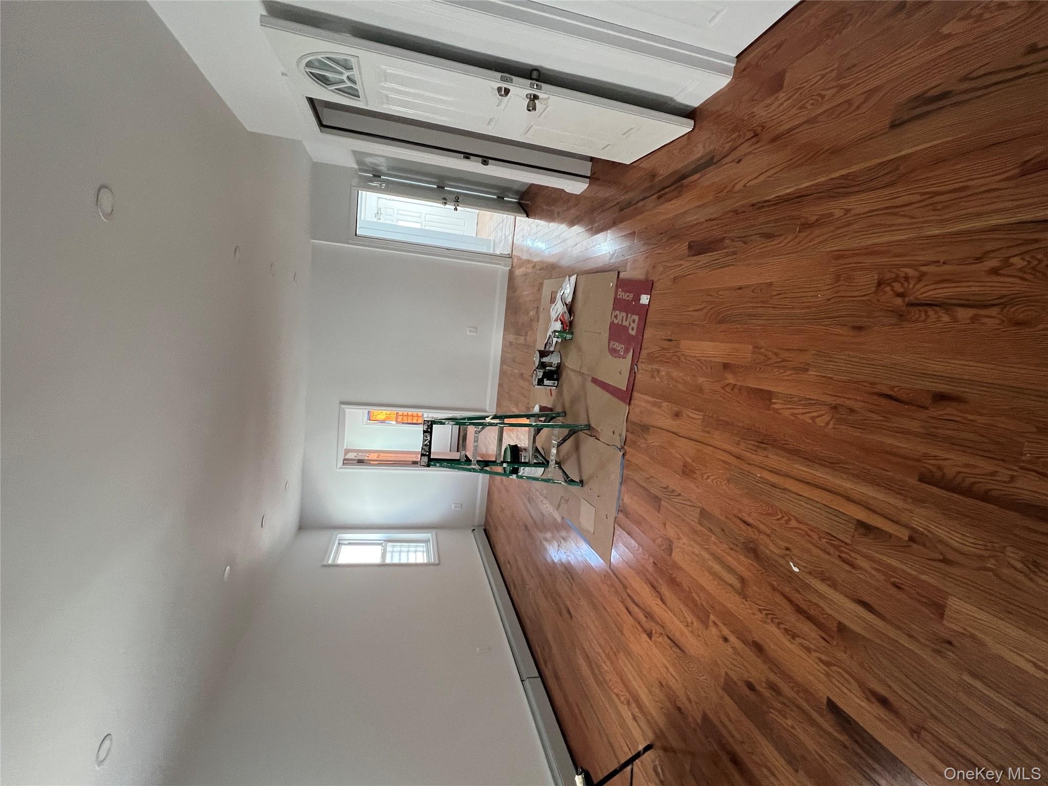 216-25 136th Road, Unit 1 2 AND 3 Queens, NY 11413 - Photo 5 of 43 a view of empty room with wooden floor
