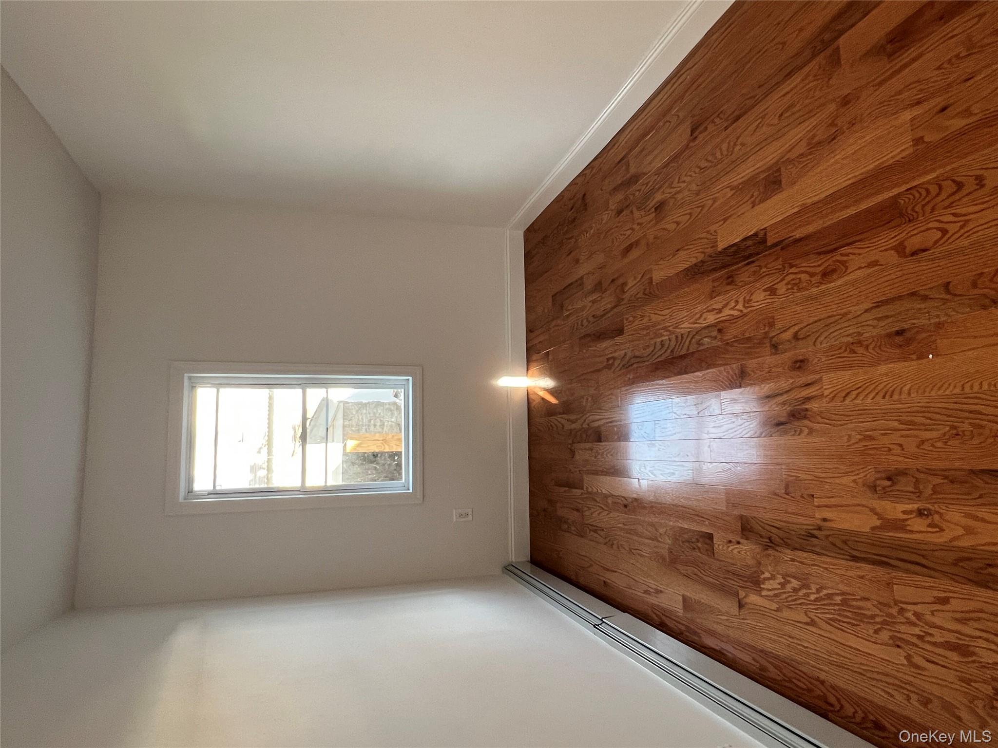 216-25 136th Road, Unit 1 2 AND 3 Queens, NY 11413 - Photo 6 of 43 an empty room with wooden floor and windows
