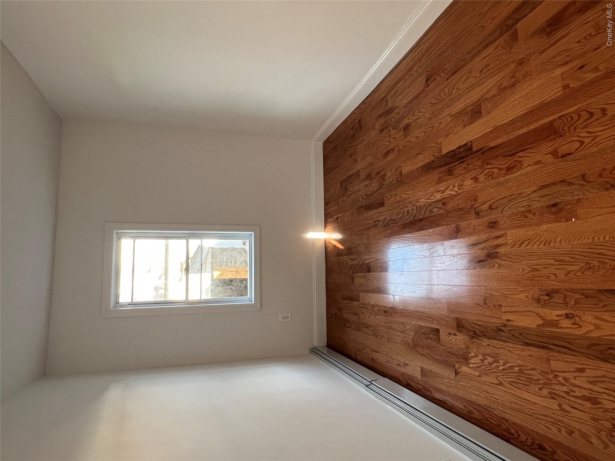 216-25 136th Road, Unit 1 2 AND 3 Queens, NY 11413 - Photo 6 of 43 an empty room with wooden floor and windows