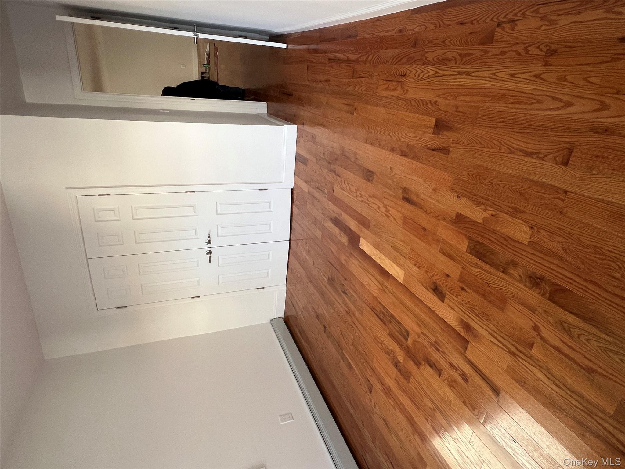 216-25 136th Road, Unit 1 2 AND 3 Queens, NY 11413 - Photo 8 of 43 a view of a room with wooden floor