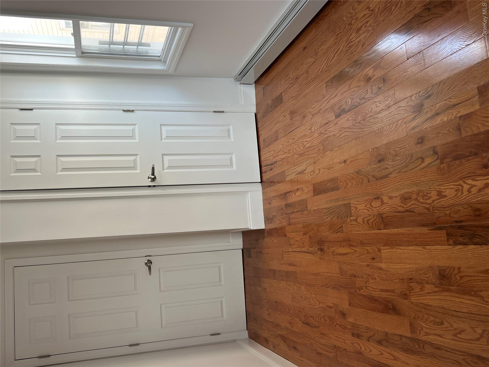 216-25 136th Road, Unit 1 2 AND 3 Queens, NY 11413 - Photo 9 of 43 a view of an empty room with wooden floor and entryway