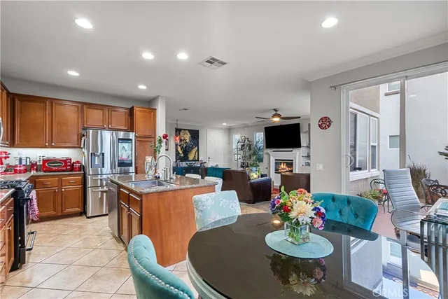 a kitchen with stainless steel appliances granite countertop a sink a stove and a refrigerator